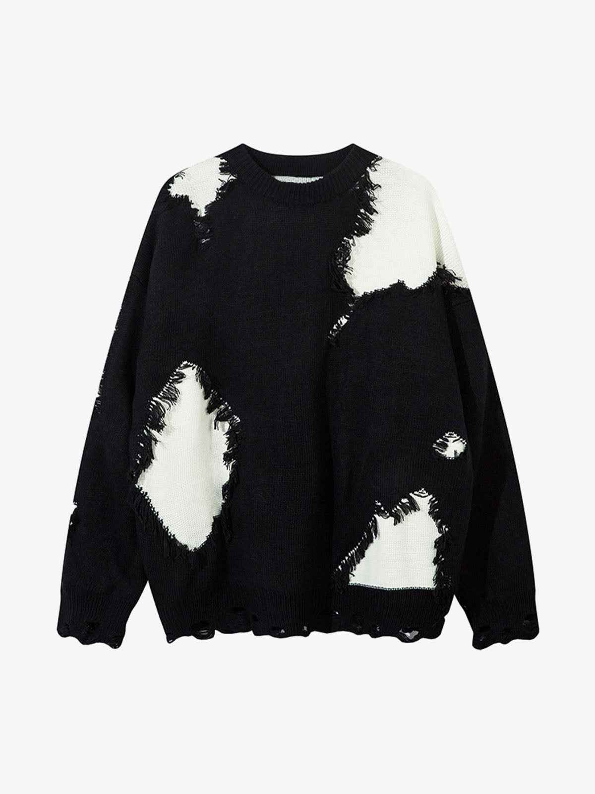 Front view of model wearing grey oversized raw edge fringed knit sweater