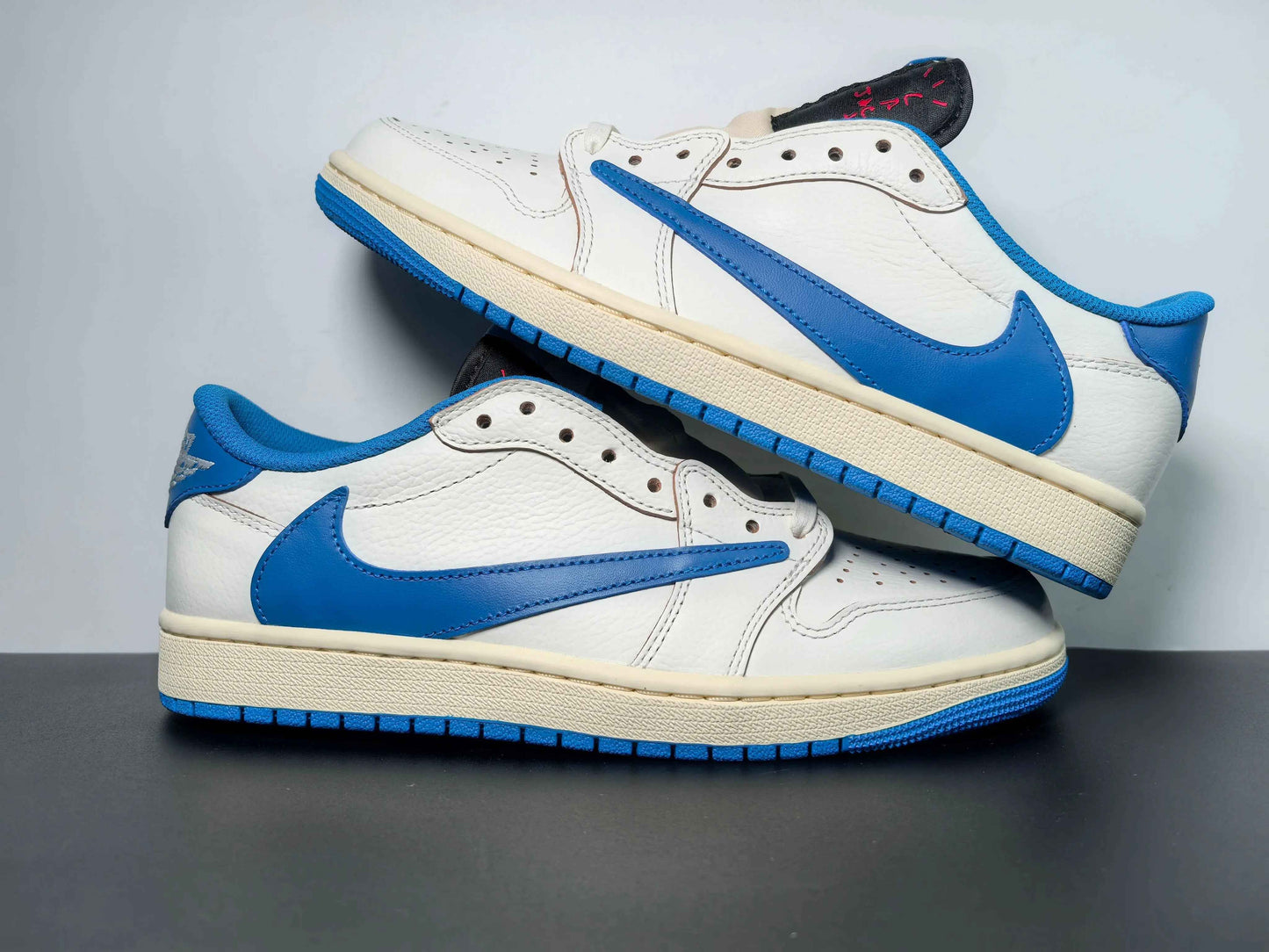 White and blue luxury urban sneakers with bold blue swoosh on display, premium streetwear style