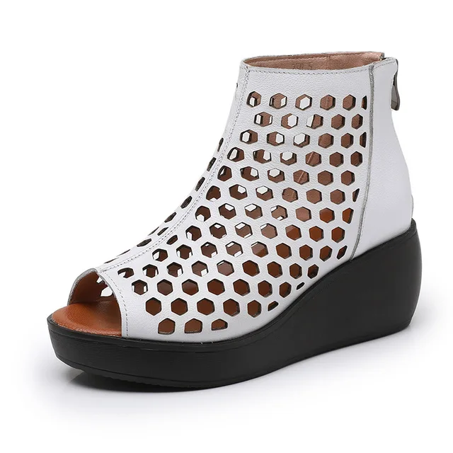 White women's summer wedge sandal with geometric cutouts and black sole, luxury urban fashion
