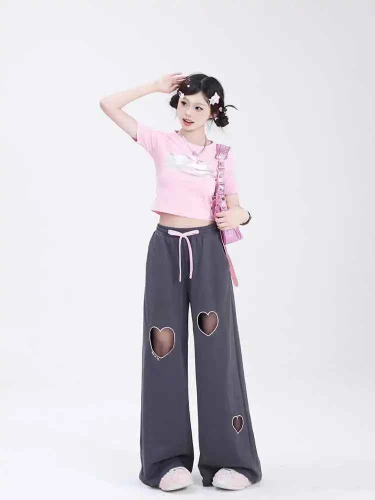 Front view of model wearing pink sweet vintage love high waist baggy sweatpants with heart embroidery
