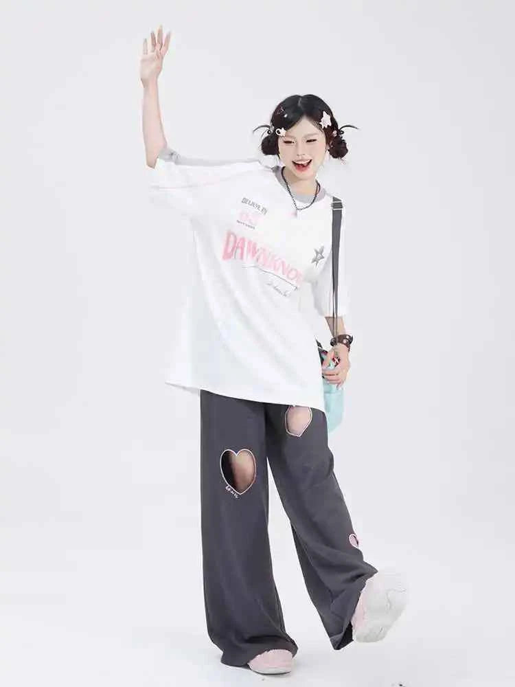 Front view of model wearing pink sweet vintage love high waist baggy sweatpants with heart embroidery