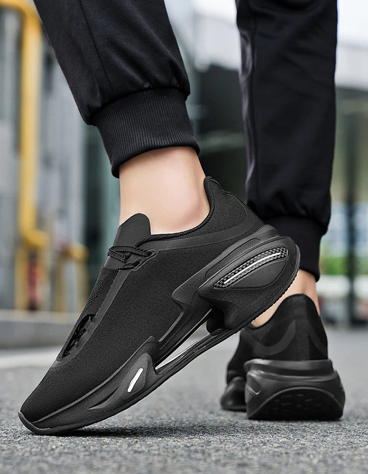 Black athletic shoes worn by a person on a blurred street background