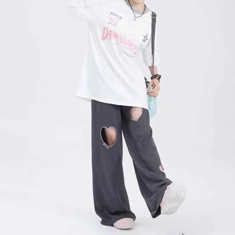 Front view of model wearing pink sweet vintage love high waist baggy sweatpants with heart embroidery