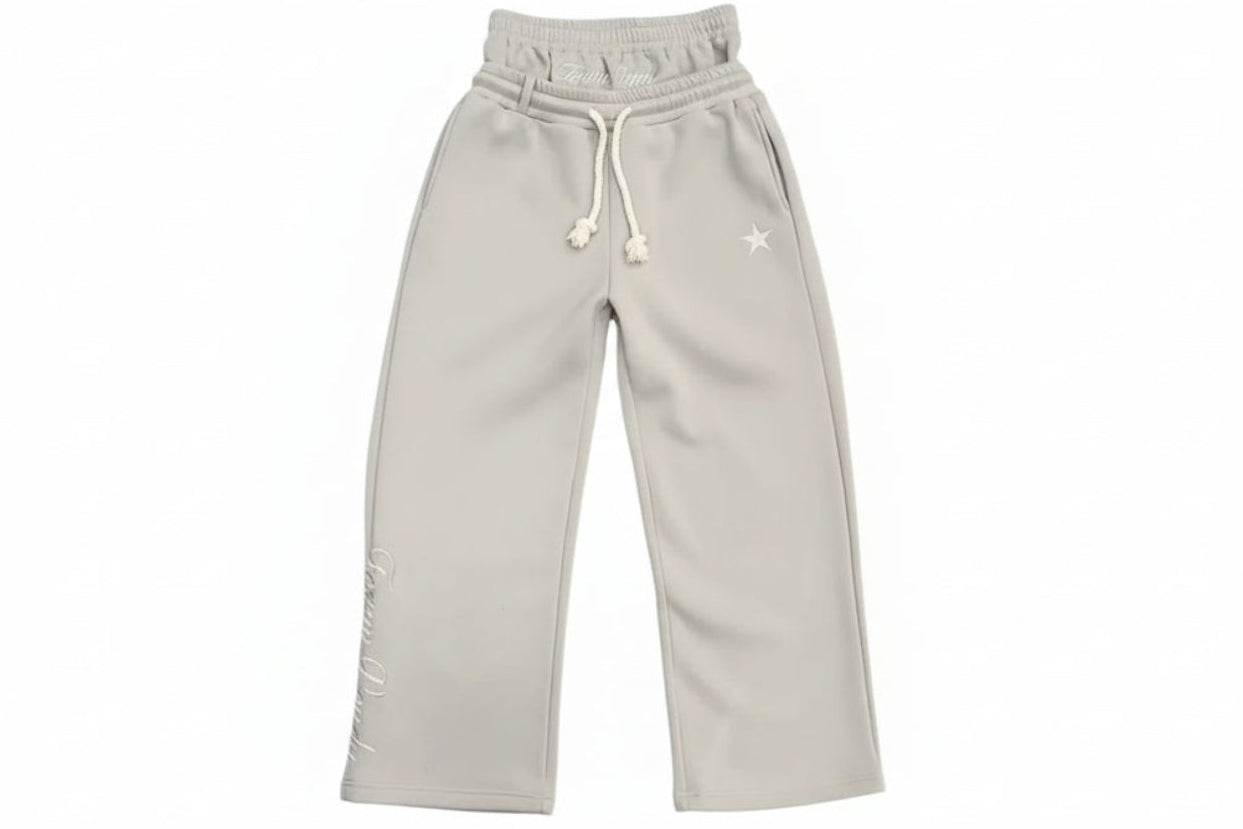 Light gray sweatpants on a gray textured floor