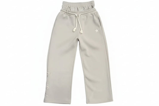 Light gray sweatpants on a gray textured floor