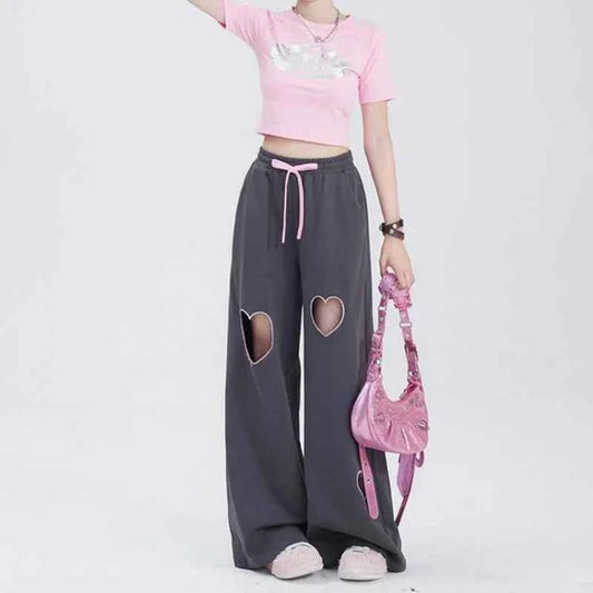 Front view of model wearing pink sweet vintage love high waist baggy sweatpants with heart embroidery