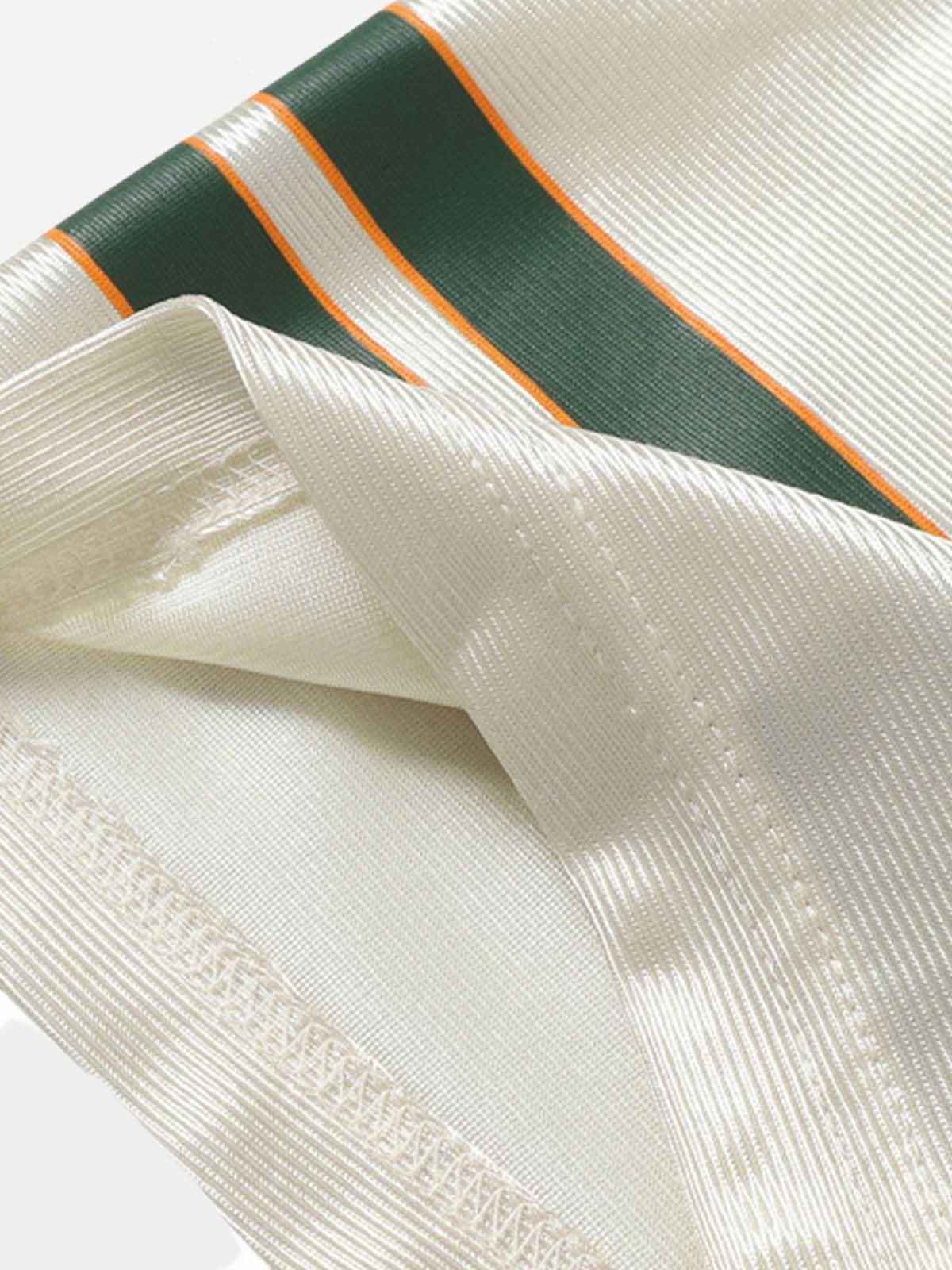 Macro shot of the 320GSM matrix-weave cotton and the reinforced cover-stitch seaming on the Gemat shirt.