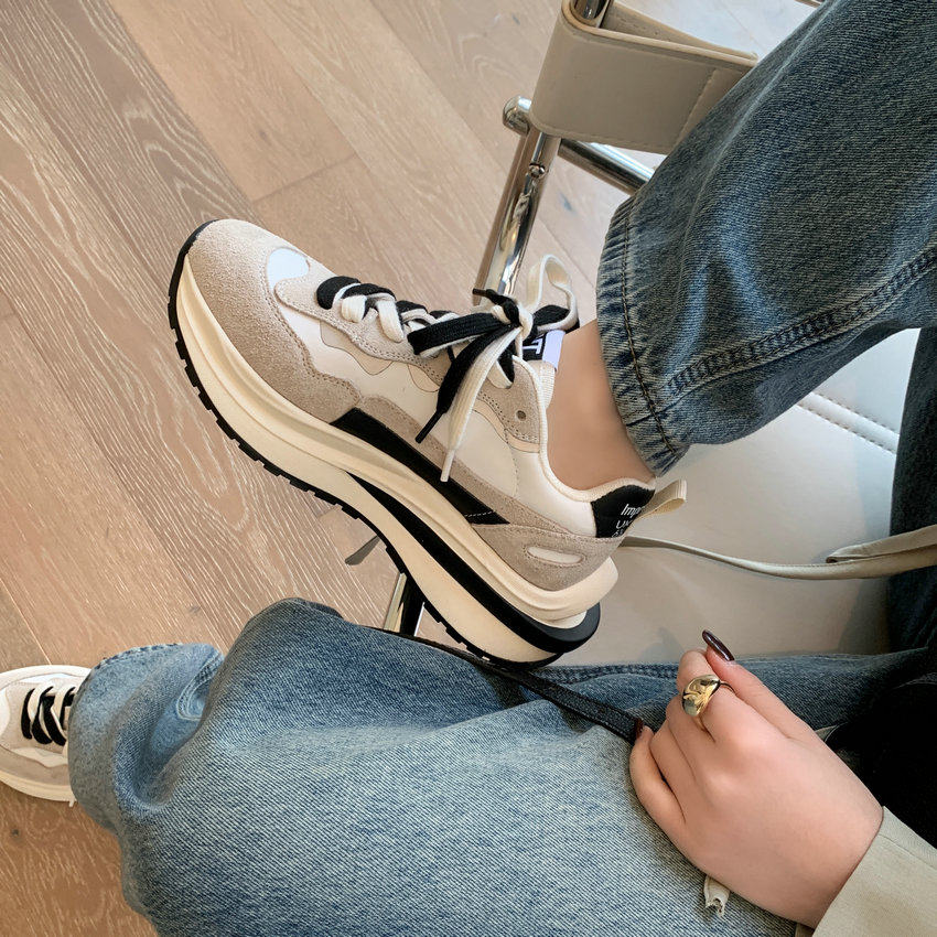 Luxuryurbanwear women's round toe lace-up sneakers in beige and white, worn with jeans