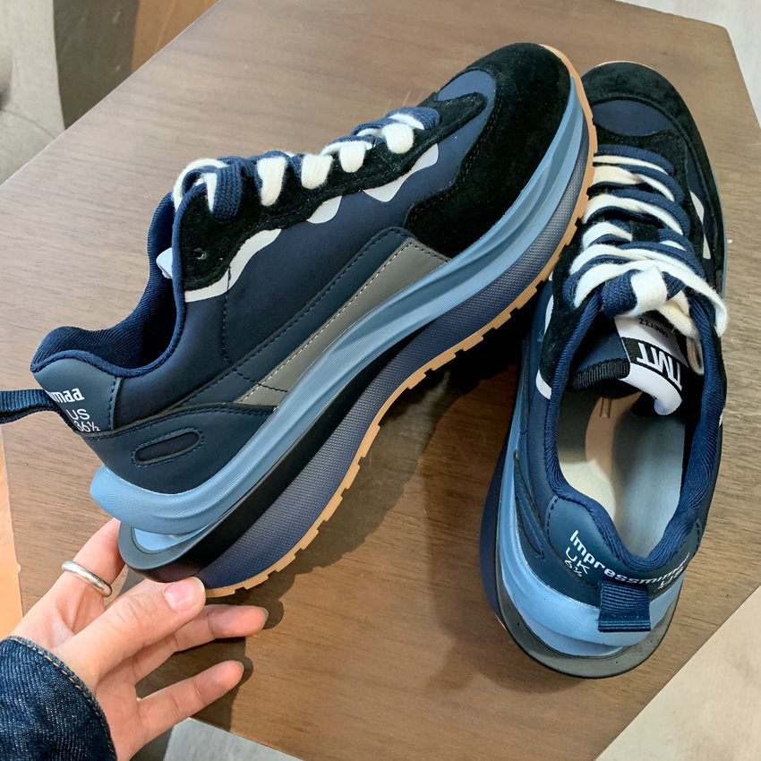 Navy women's luxury urban round toe lace-up sneakers with suede and mesh, on wood table.