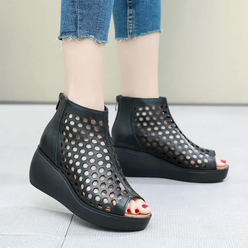 Black women's summer wedge sandals with cutout design, styled with denim for urban fashion